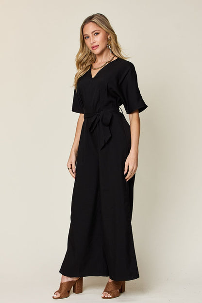 Double Take Full Size V-Neck Tie Front Short Sleeve Slit Jumpsuit Black Jumpsuits by Trendsi | Fleurcouture