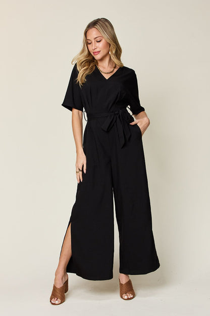 Double Take Full Size V-Neck Tie Front Short Sleeve Slit Jumpsuit Black S Jumpsuits by Trendsi | Fleurcouture