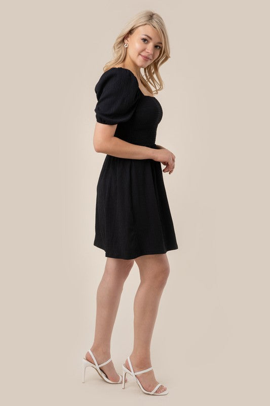 Puff sleeved smocked dress Black by Lilou | Fleurcouture